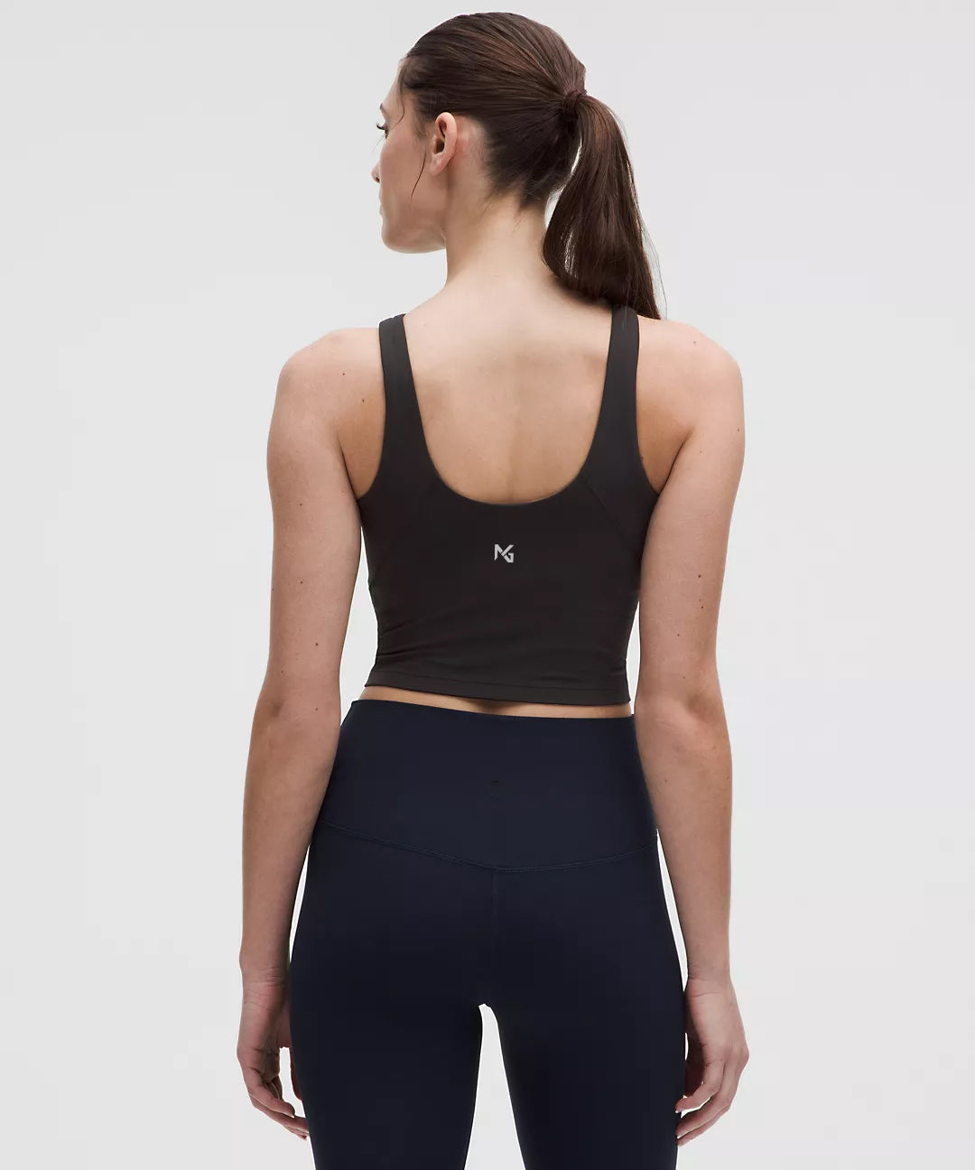 Back View of Woman Wearing Black Natural Gas Tank Top – NG Logo Centered Between Shoulder Blades – Sleek Athletic Fit