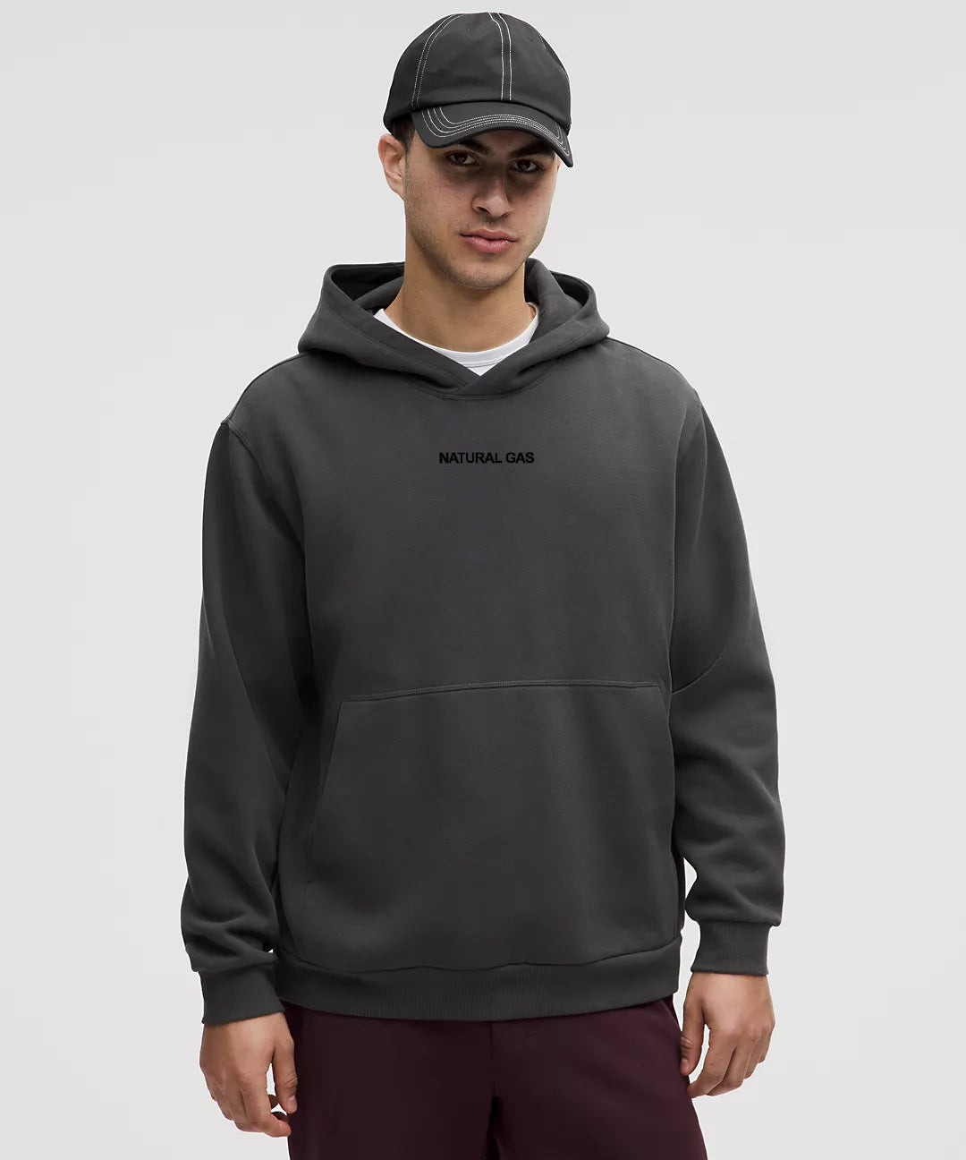 Men’s front view of charcoal grey Natural Gas hoodie with minimalist black embroidered logo, athletic streetwear style.