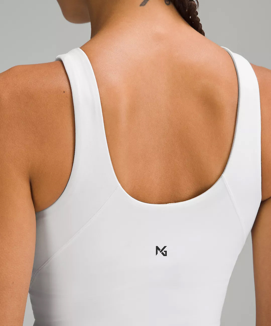 Back View of White Women’s Athletic Tank Top – Natural Gas Branded Tag Detail – Fitted Racerback Design for Training or Gym Wear