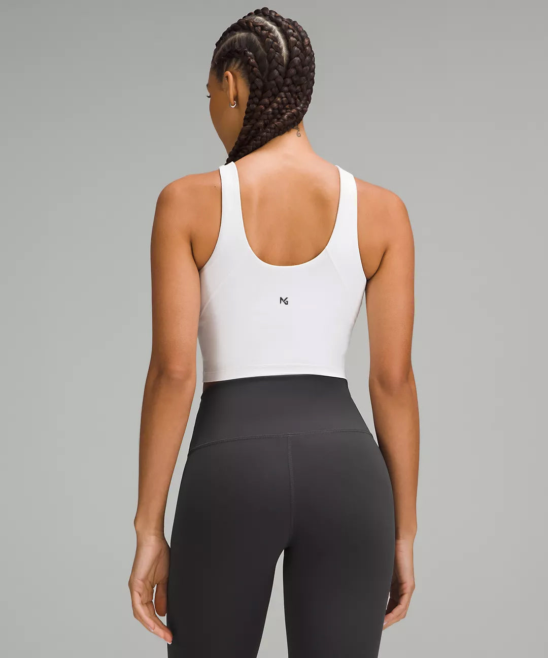 Back View of Woman Wearing White Natural Gas Tank Top – Racerback Crop with Black High-Waisted Leggings – Clean Athletic Fit for Gym or Training