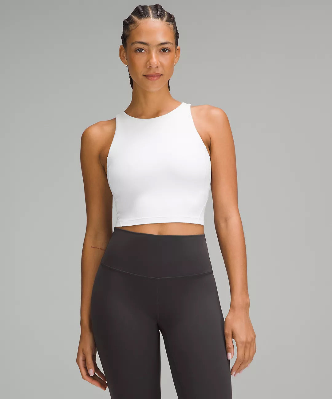 Front View of Woman Wearing White Natural Gas Cropped Tank Top – High Neck Athletic Fit with Black Leggings – Clean Minimalist Gym Apparel