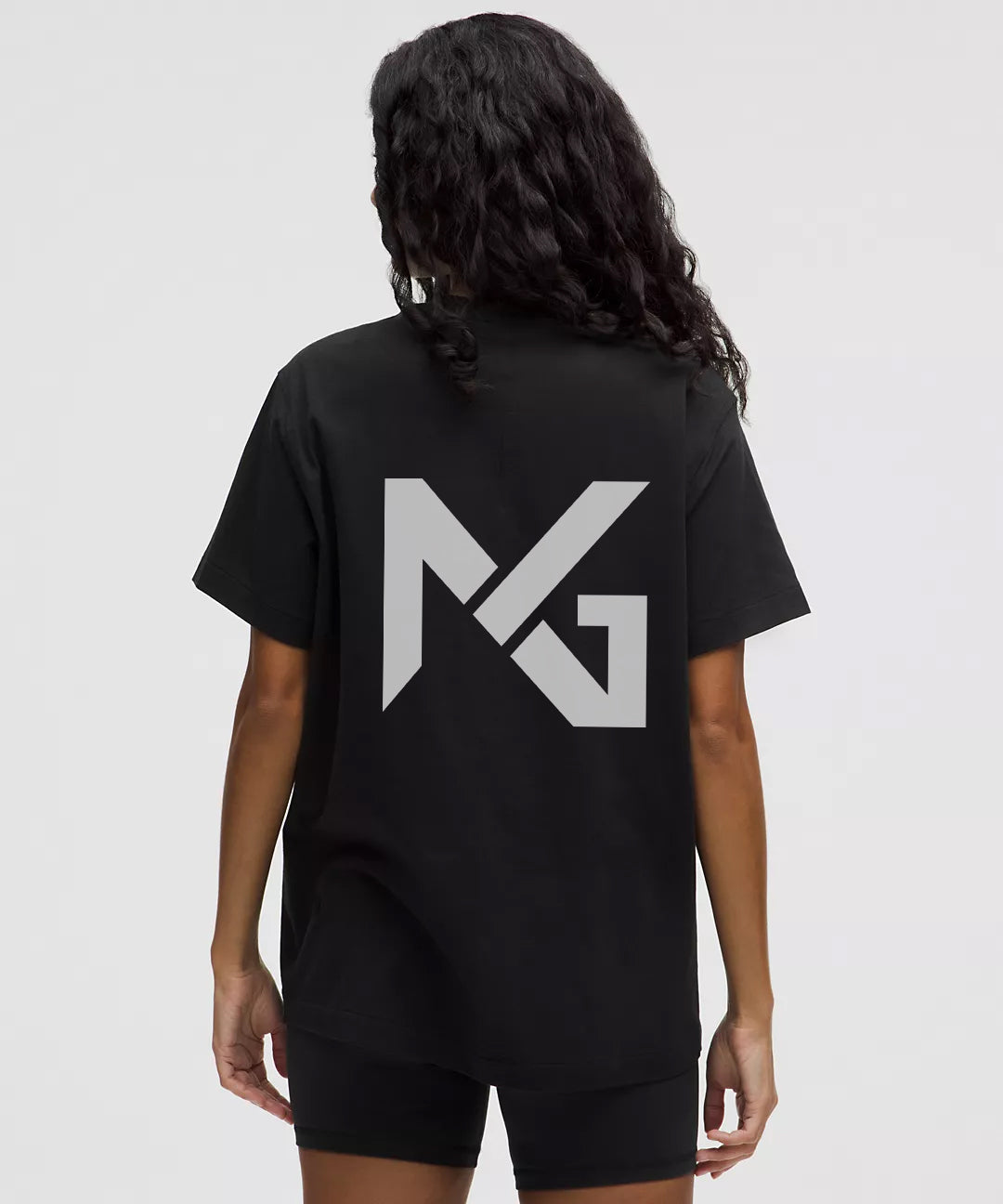Back view of Natural Gas women's oversized black t-shirt featuring bold NG logo graphic in grey, ideal for streetwear or gym wear.